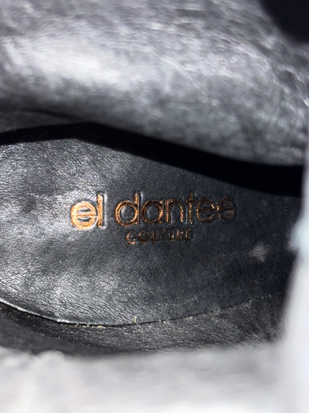 Knee-high boot lining with el dantes logo, dark leather interior detail