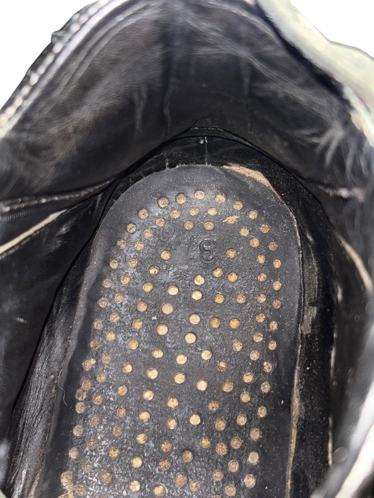 Black leather platform boot insole with round stud pattern