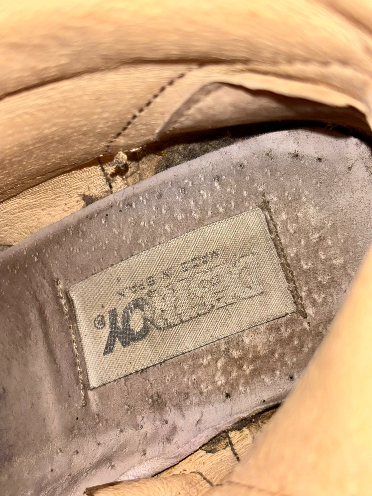Beige leather boot insole lining with DESTROY logo patch and stitched edge detail.