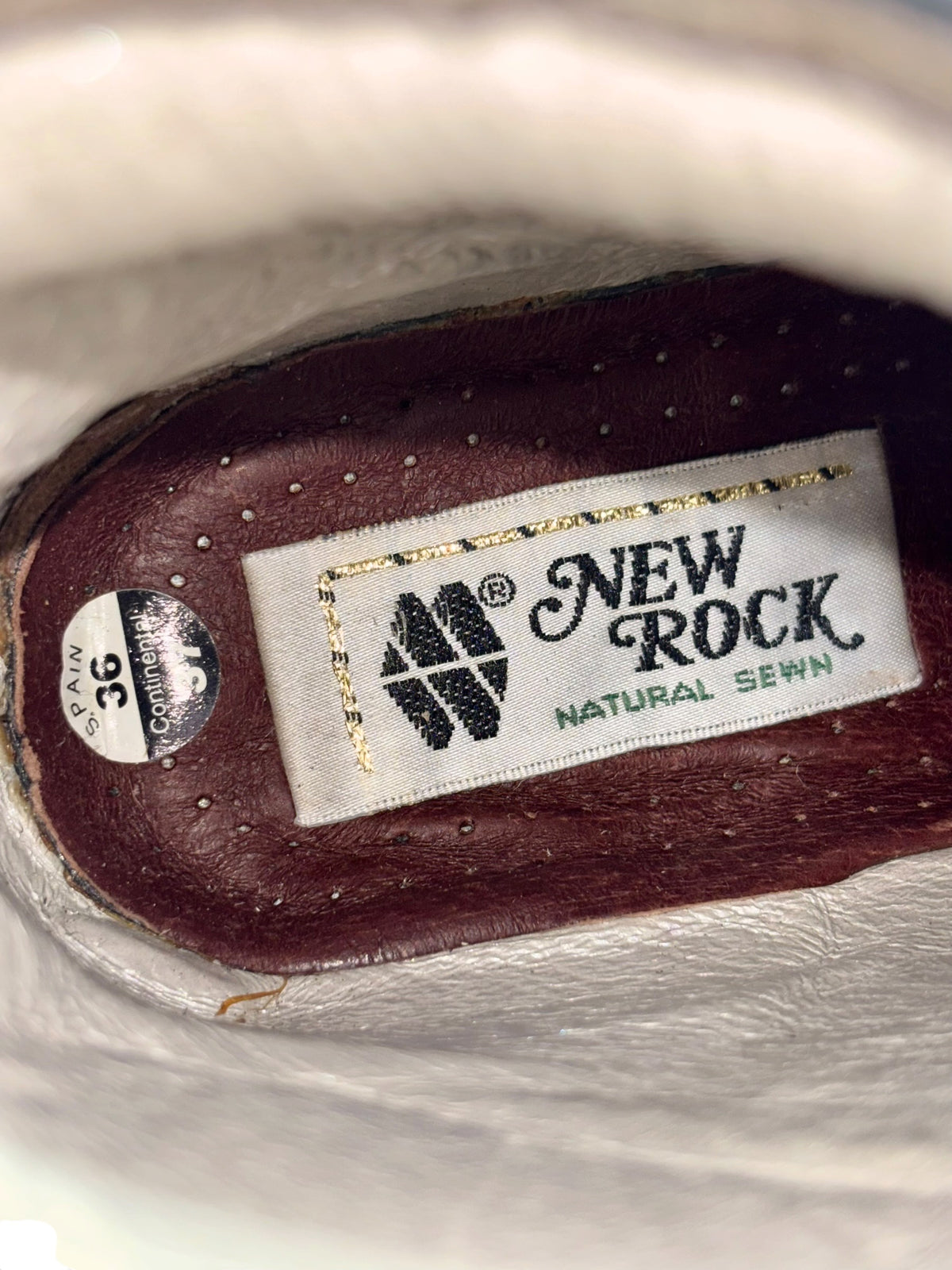 Platform heel shoe insole with brand label and dark maroon interior lining.