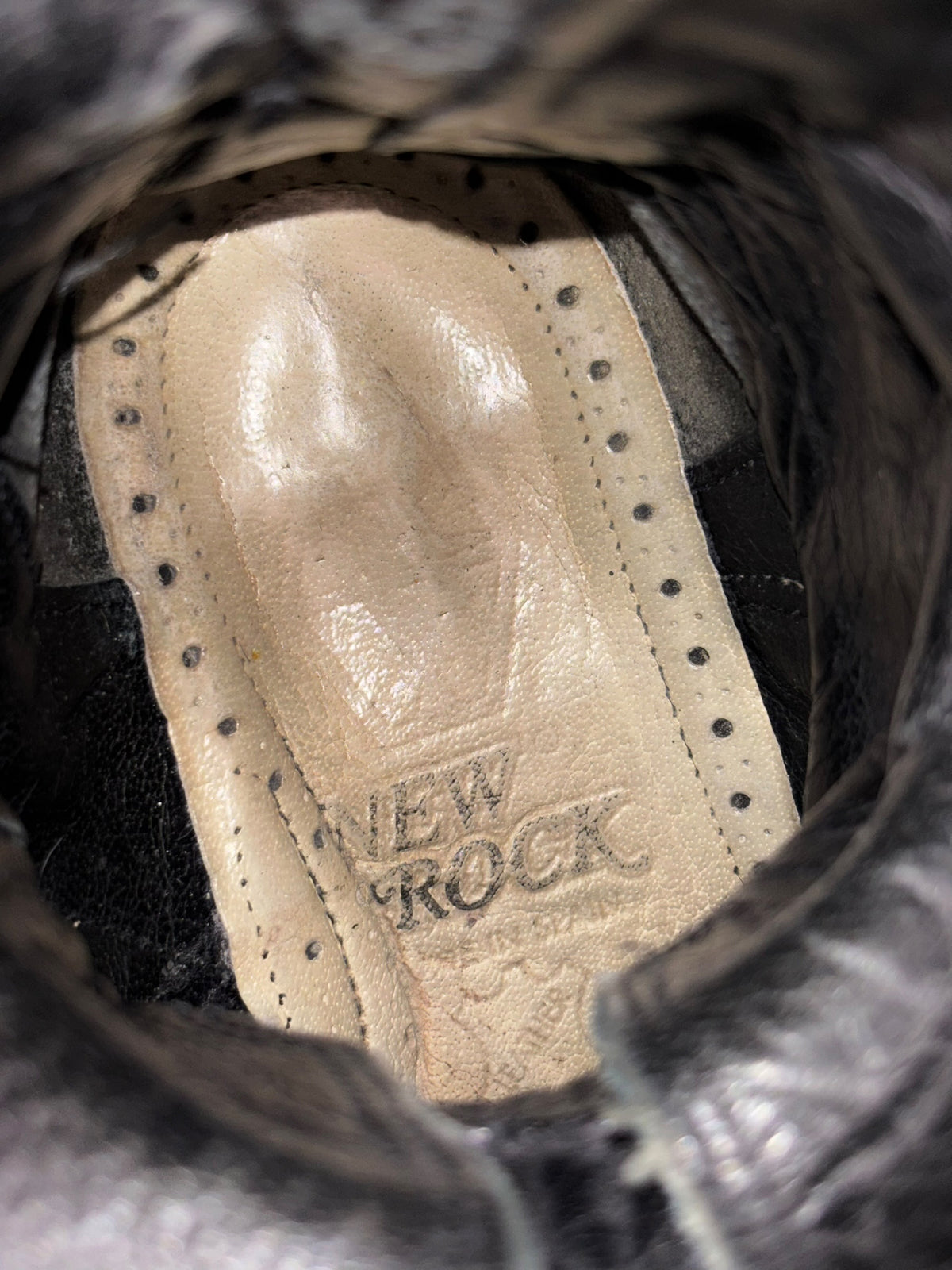Vintage triple-buckle leather boot interior, light tan insole with logo mark