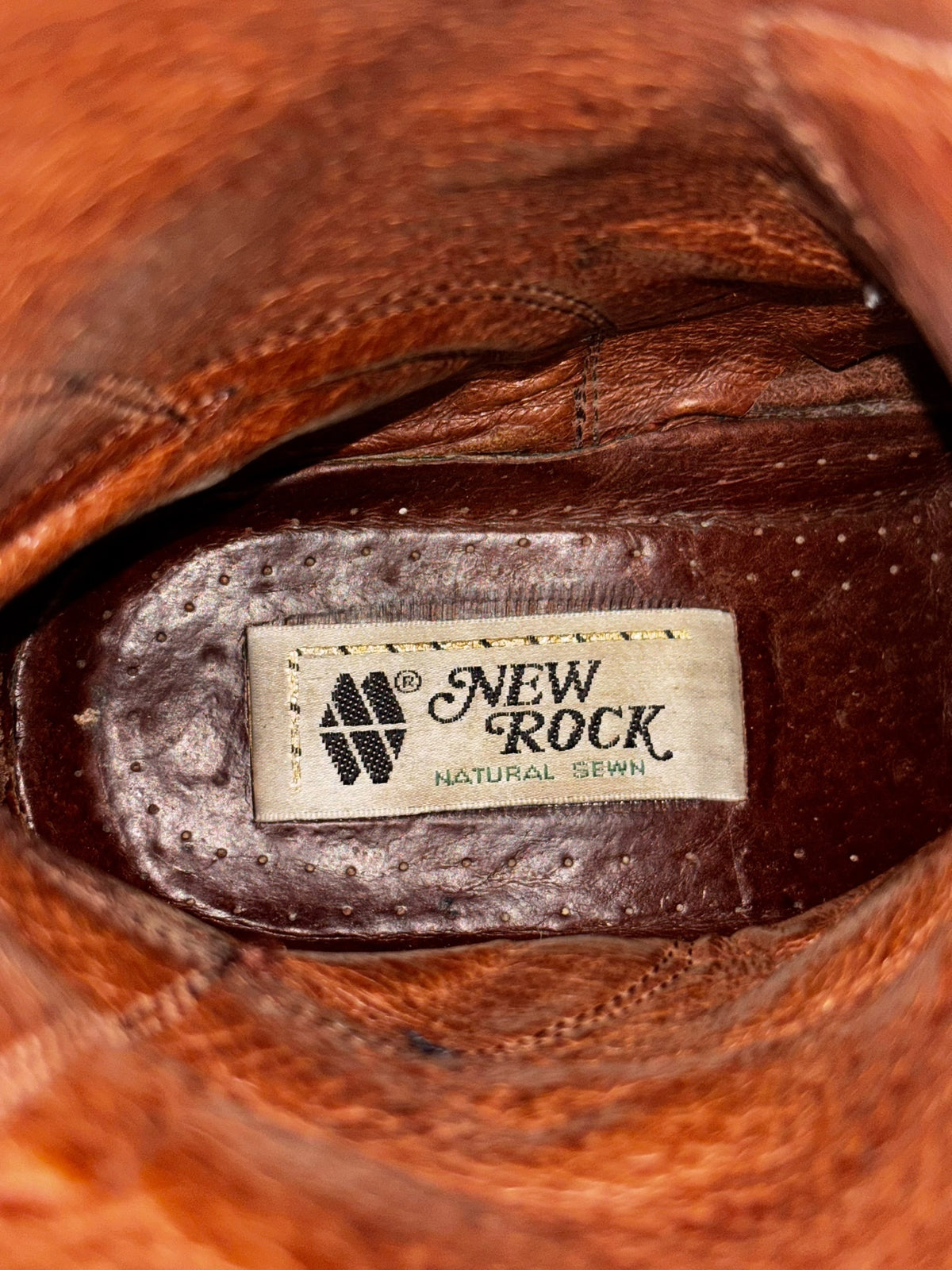 Boot insole label reading “New Rock Natural Sewn” on dark leather