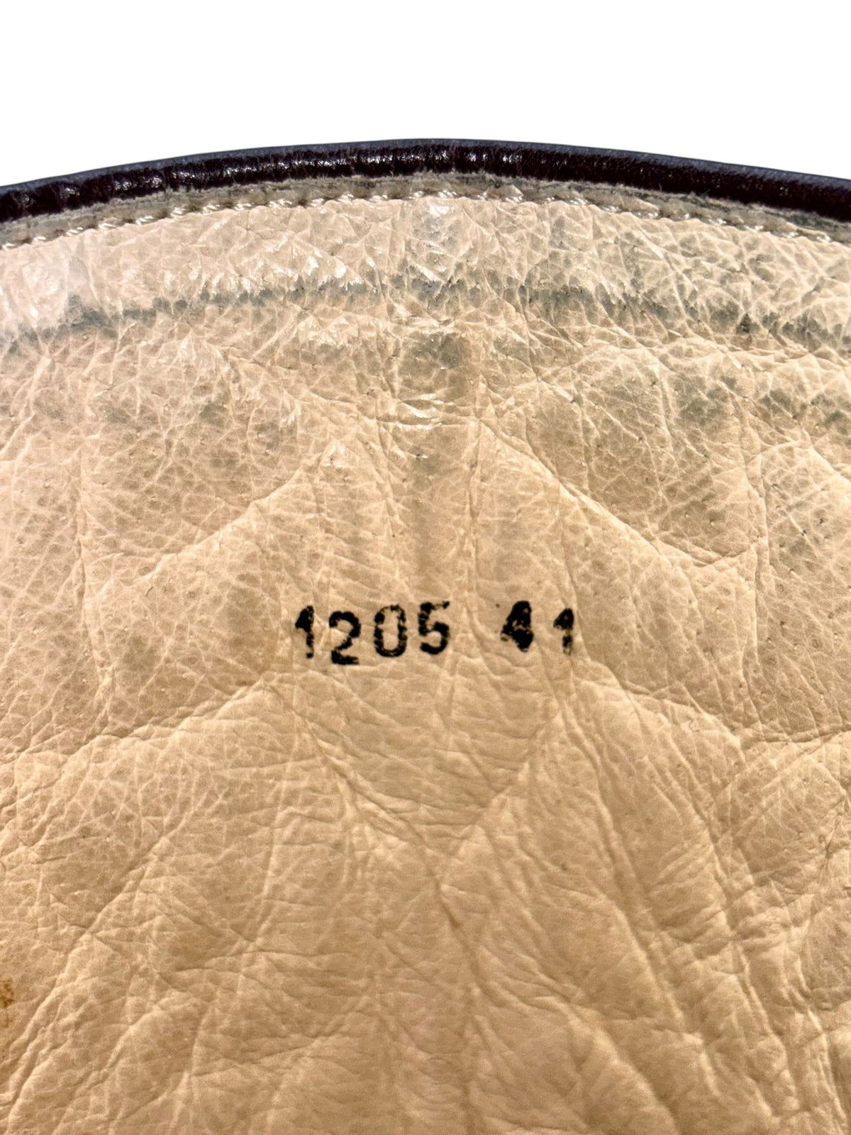 Beige leather boot lining with size stamp and fabric grain detail