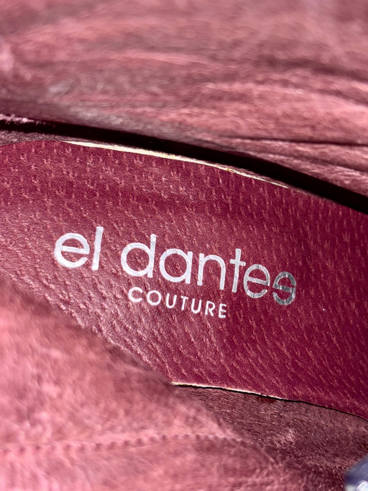 Leather boot insole with el dantes Couture logo and stitched edge.