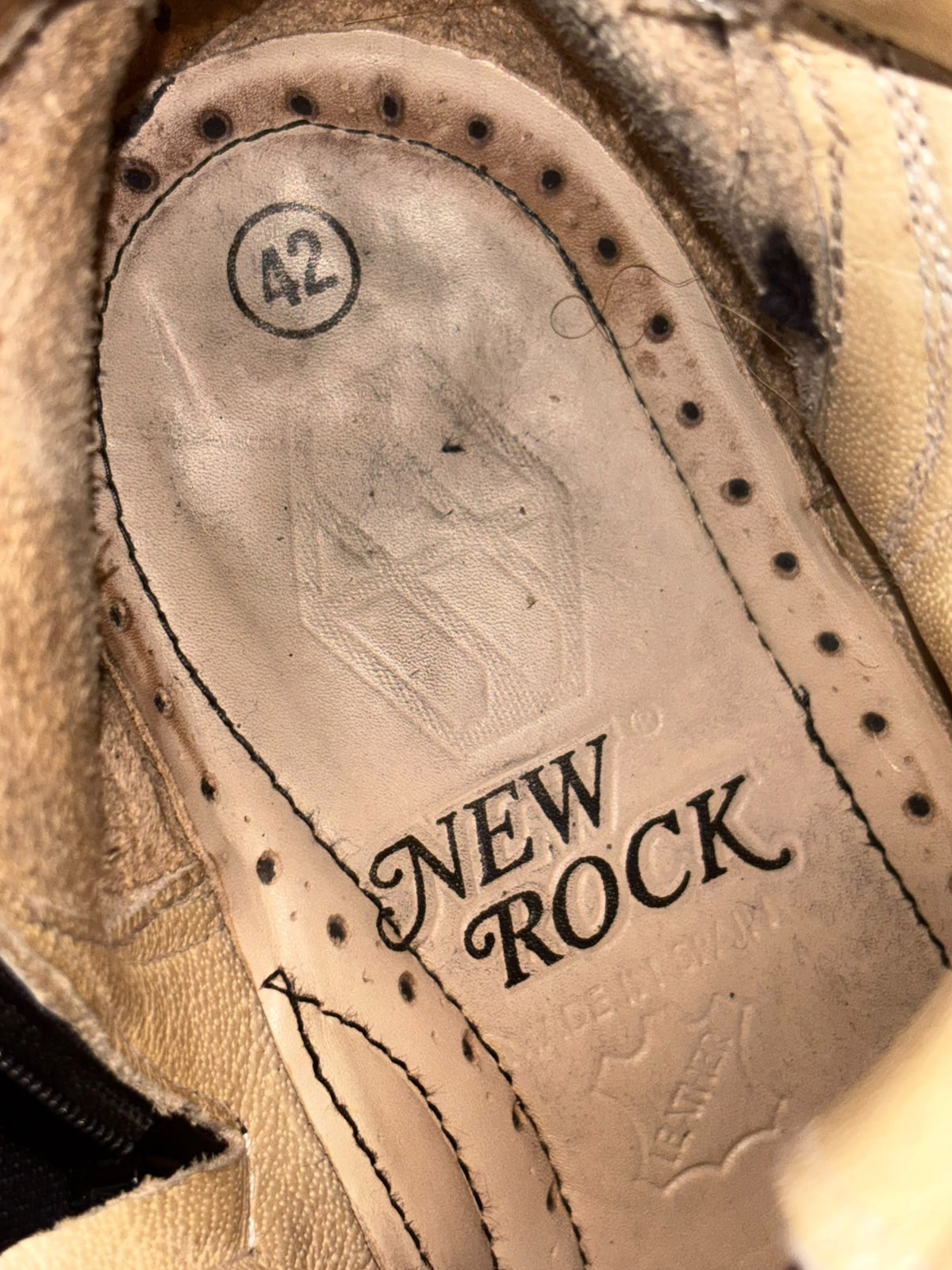 Vintage-style black leather trailer platform boots, interior logo detail on insole.