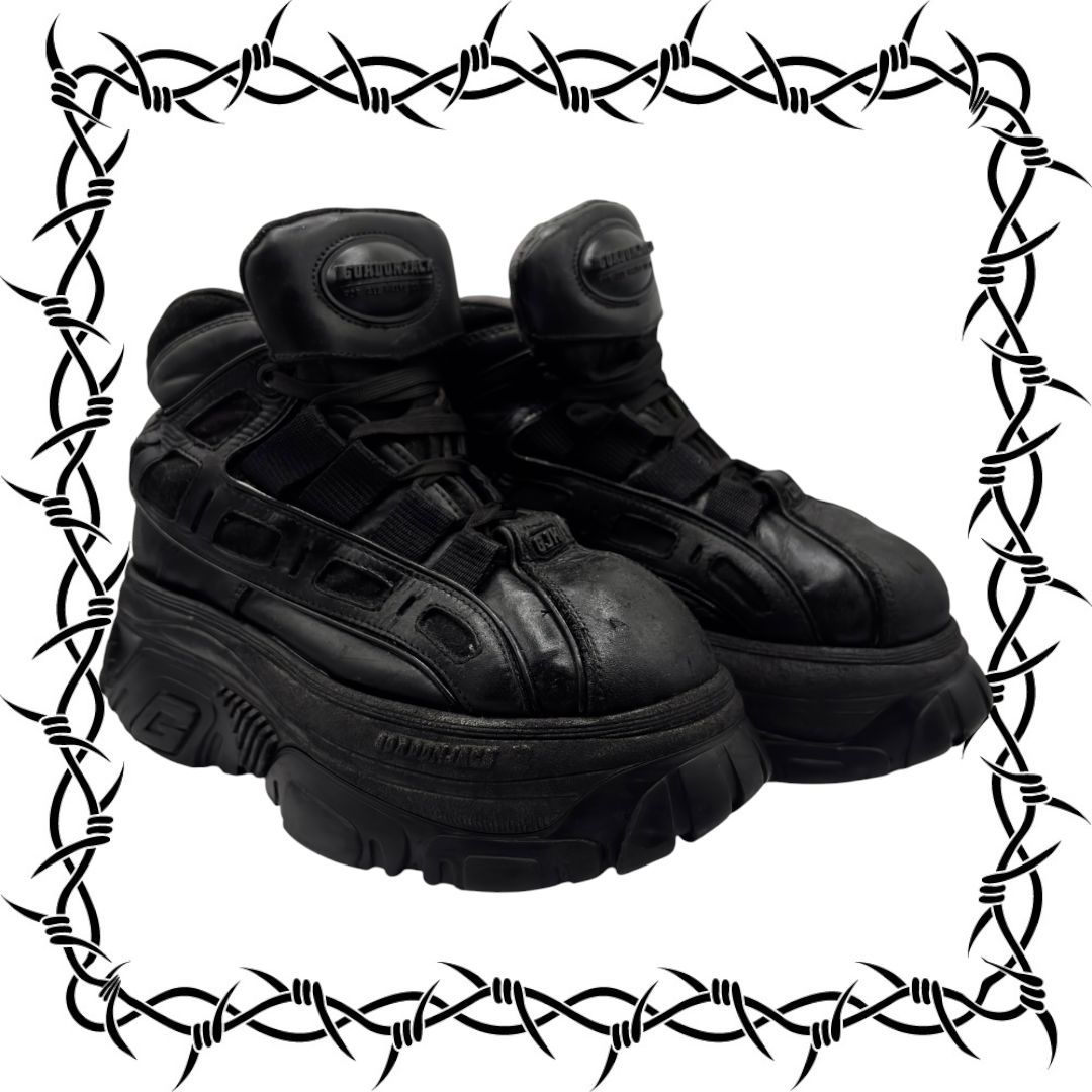 Black lace-up platform boots with dual uppers and chunky tread outsole