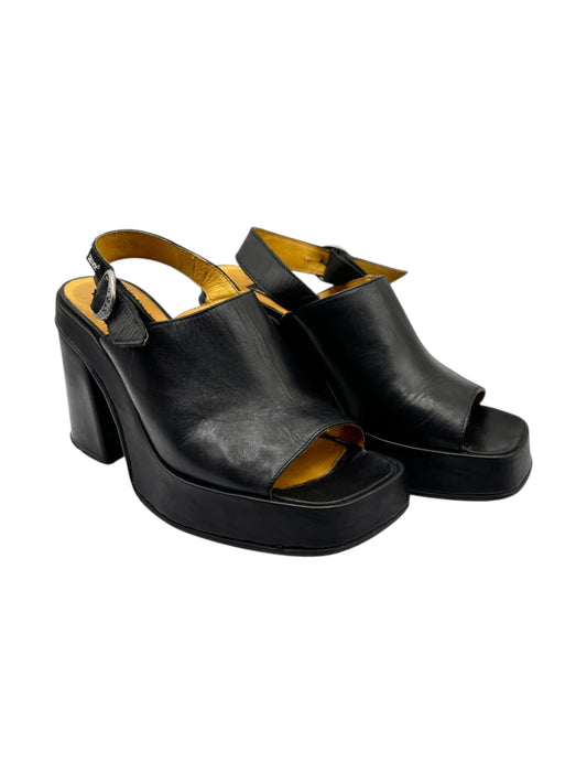 Two black platform sandals with thick heels, open toe, and adjustable straps