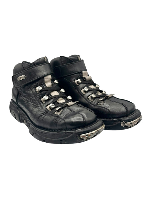 Black leather high-top sneakers with lace-up front, side straps, and worn outsole edges