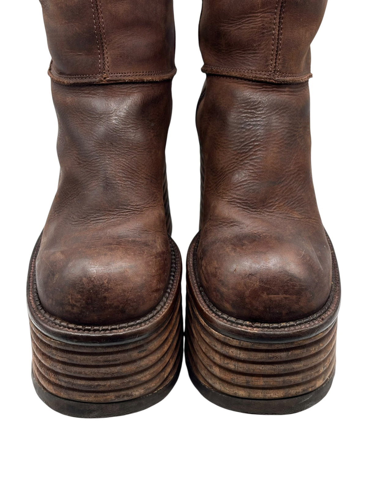 Brown knee-high leather platform boots with stacked block heel
