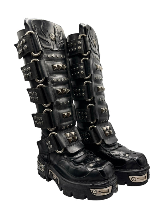 Black knee-high studded leather boots with multiple straps and silver spikes