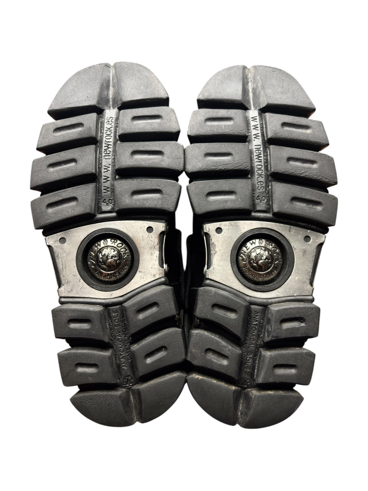 Pair of knee-high boot outsoles showing chunky tread and metal toe plates