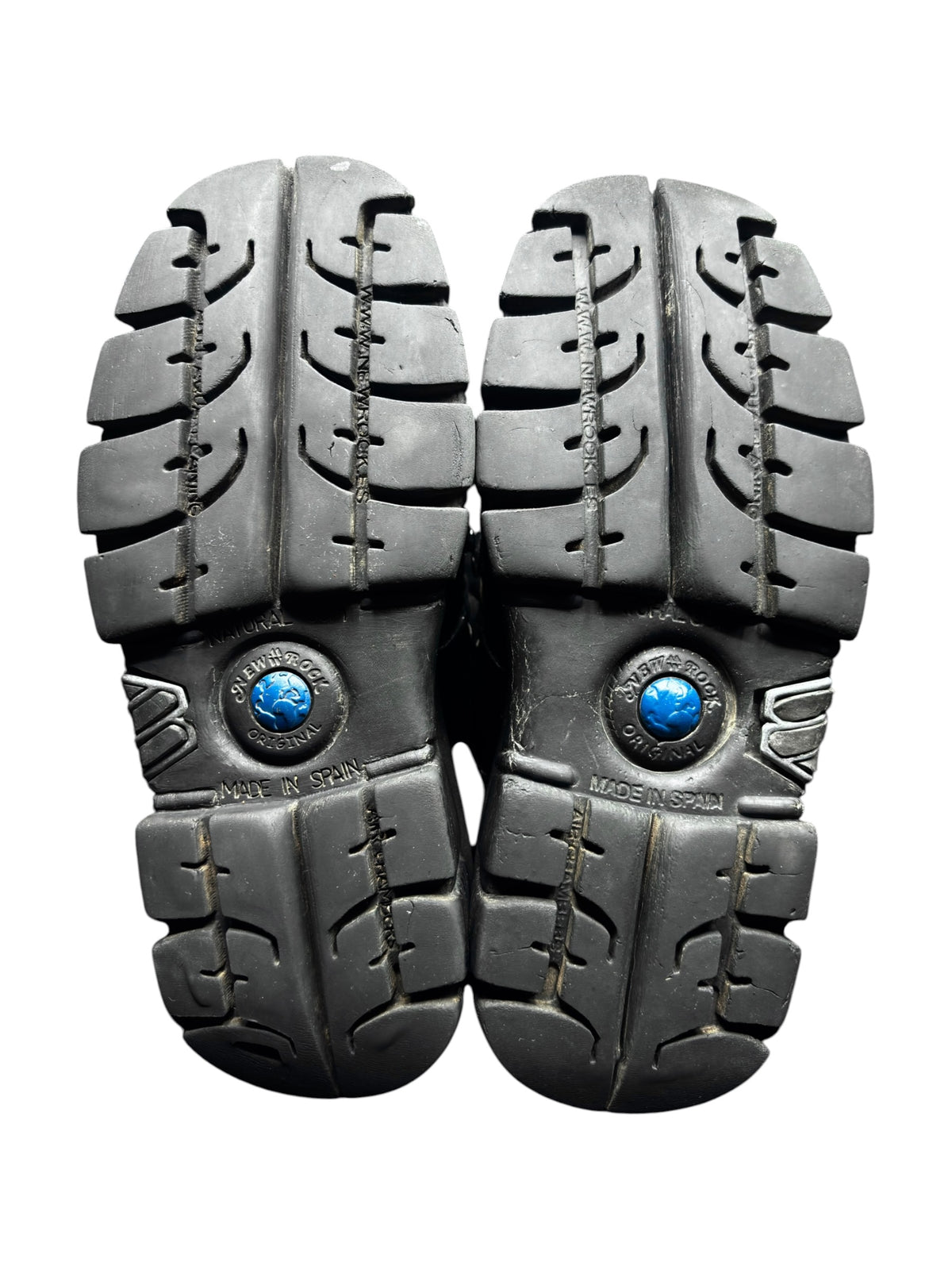 Pair of black platform boot outsoles with chunky tread and blue logo caps