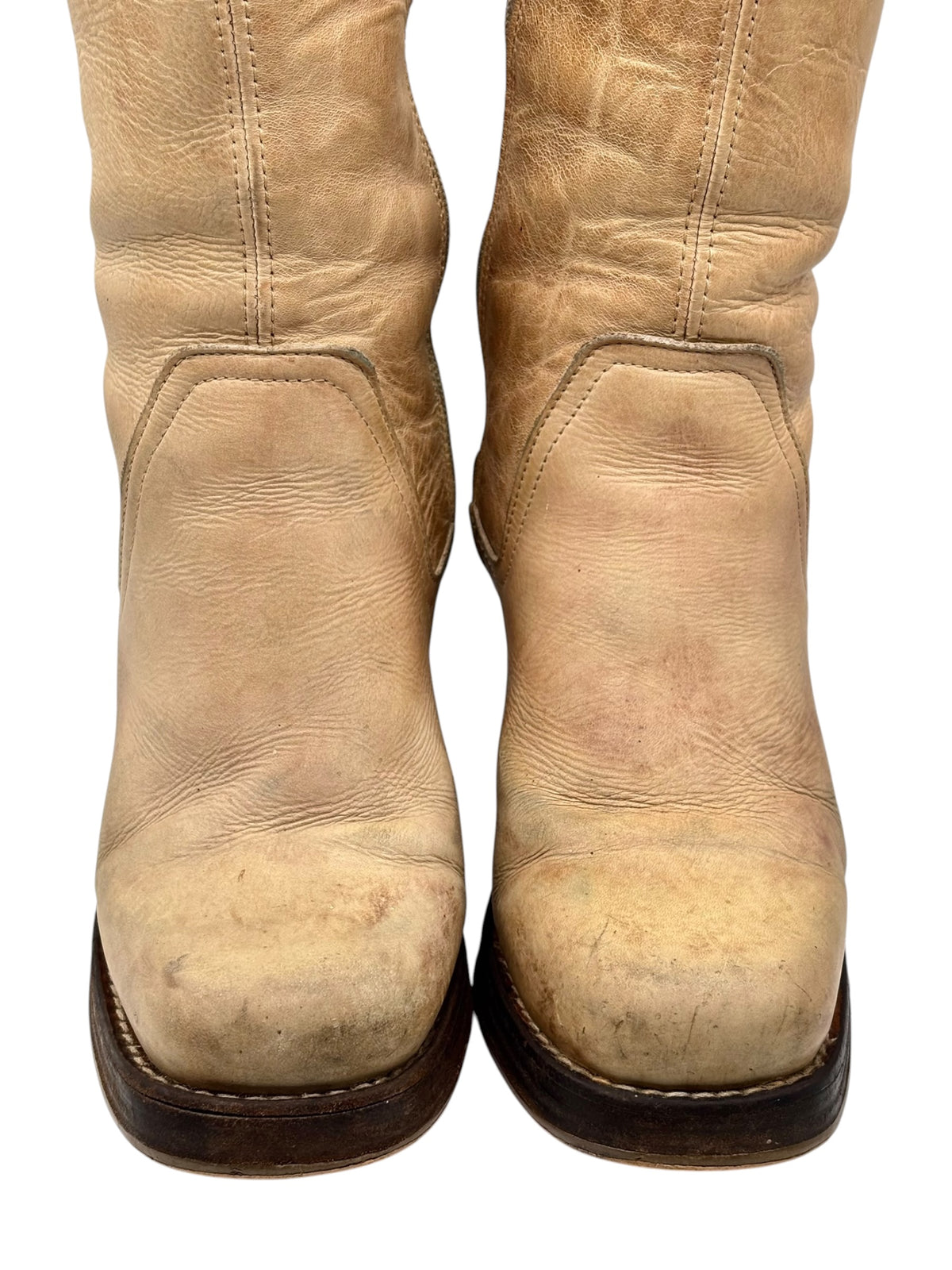Beige knee-high leather block-heel boots with worn vintage finish, side panel seams
