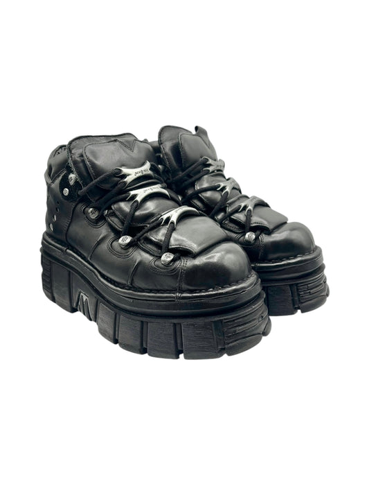 Black lace-up platform boots pair shown from front-left angle with chunky sole
