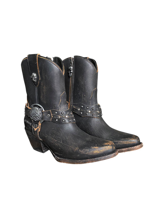 Black leather cowboy boots with side zippers, studded band, and skull buckle detail