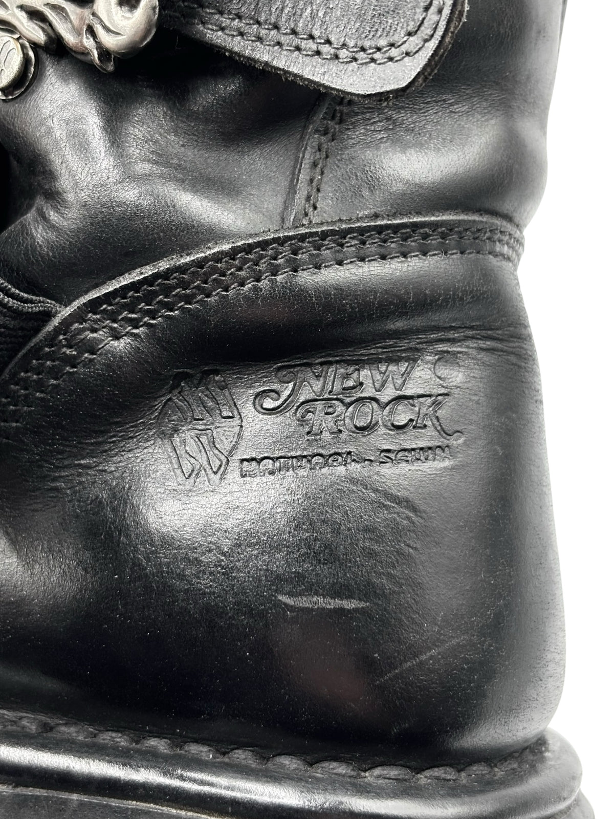 Close-up of black leather New Rock heel area with embossed logo and stitching