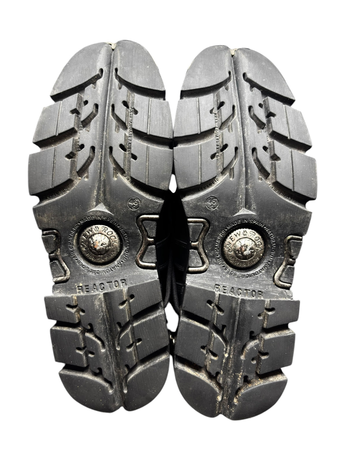Pair of rugged outsole soles with deep tread and circular logo medallions