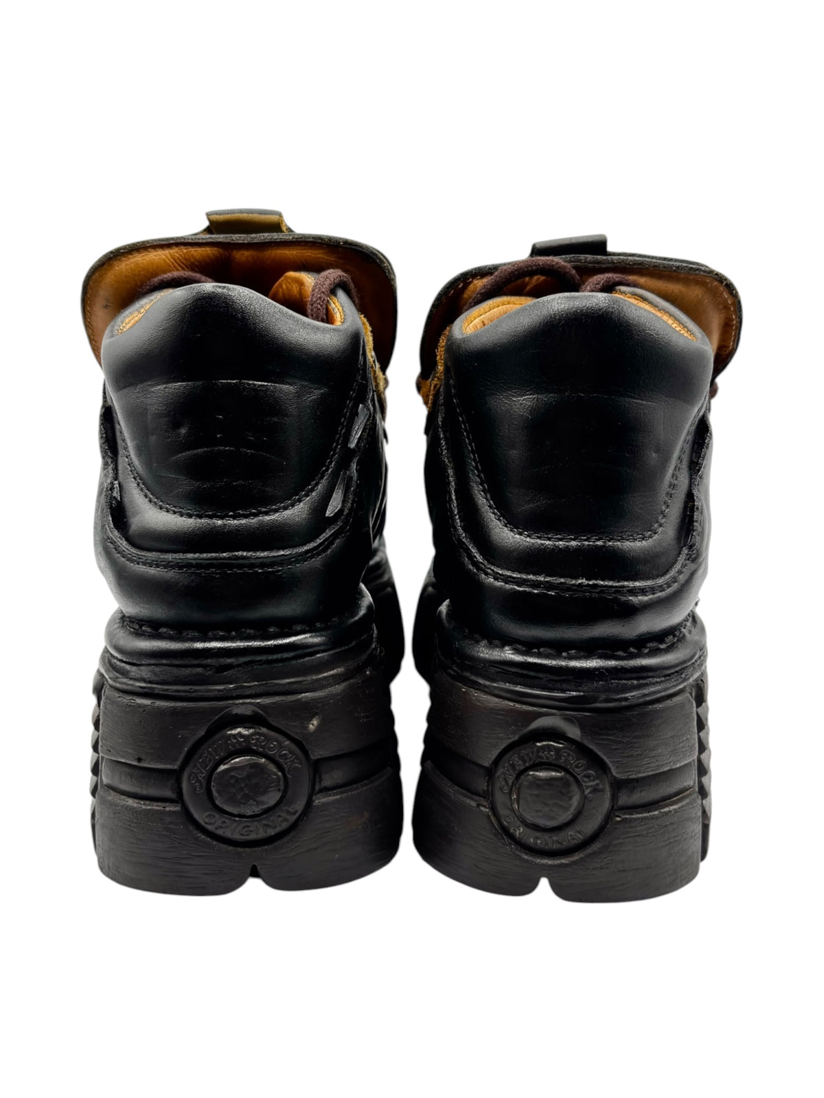 Back view of black platform boots with cushioned heel collars and circular heel logos.