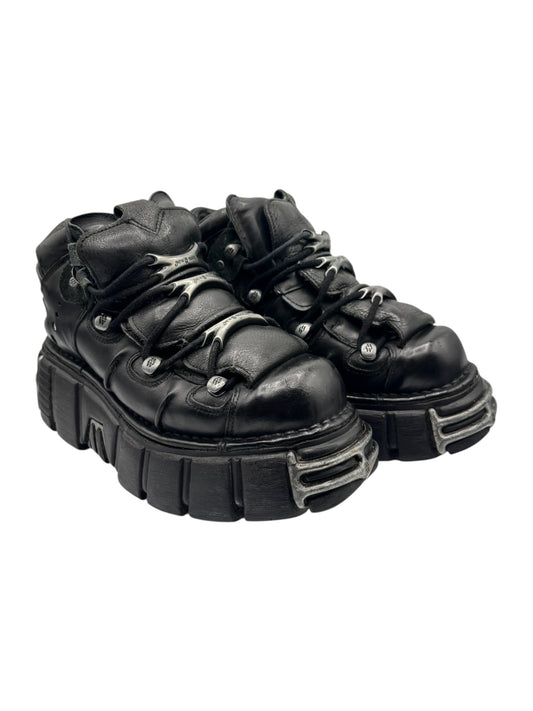 Black platform lace-up boots with chunky sole and silver-tone toe plates