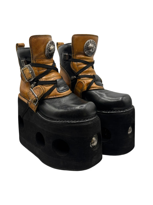 Black and tan lace-up platform boots with buckles, round toe, thick sole, vintage style.