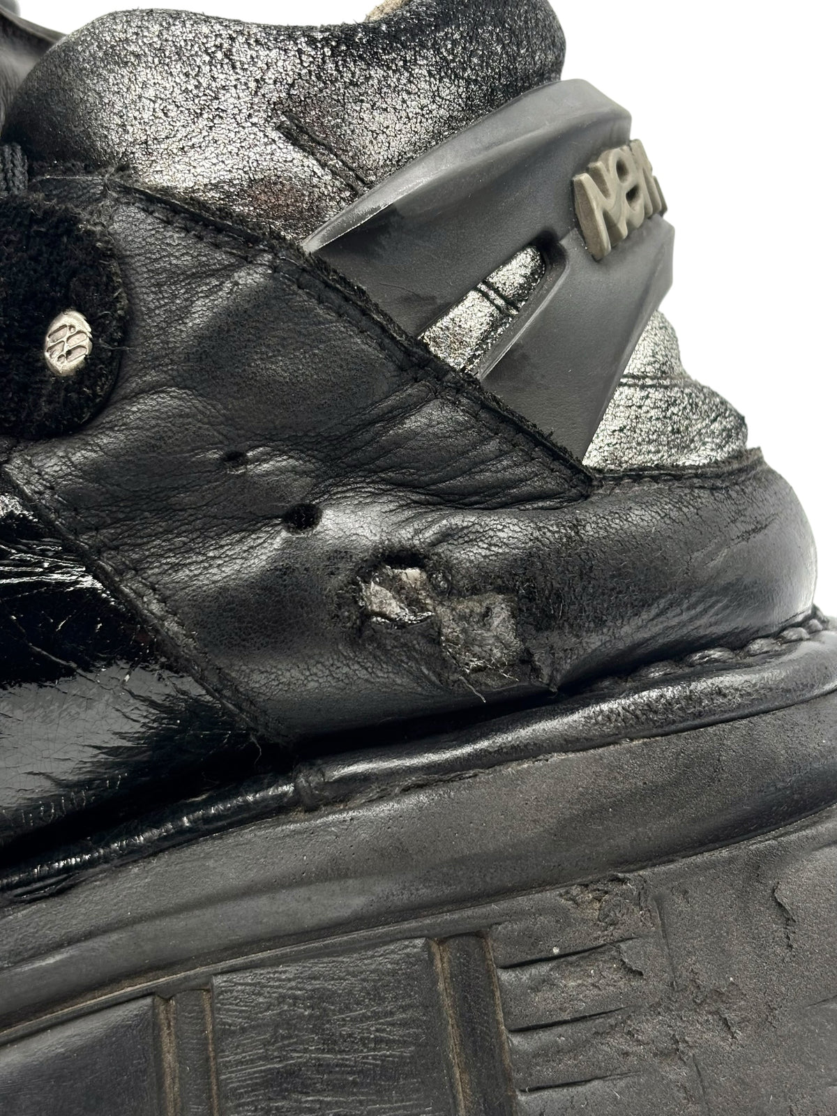 Vintage New Rock platform boots, close-up of black leather upper and embossed detail