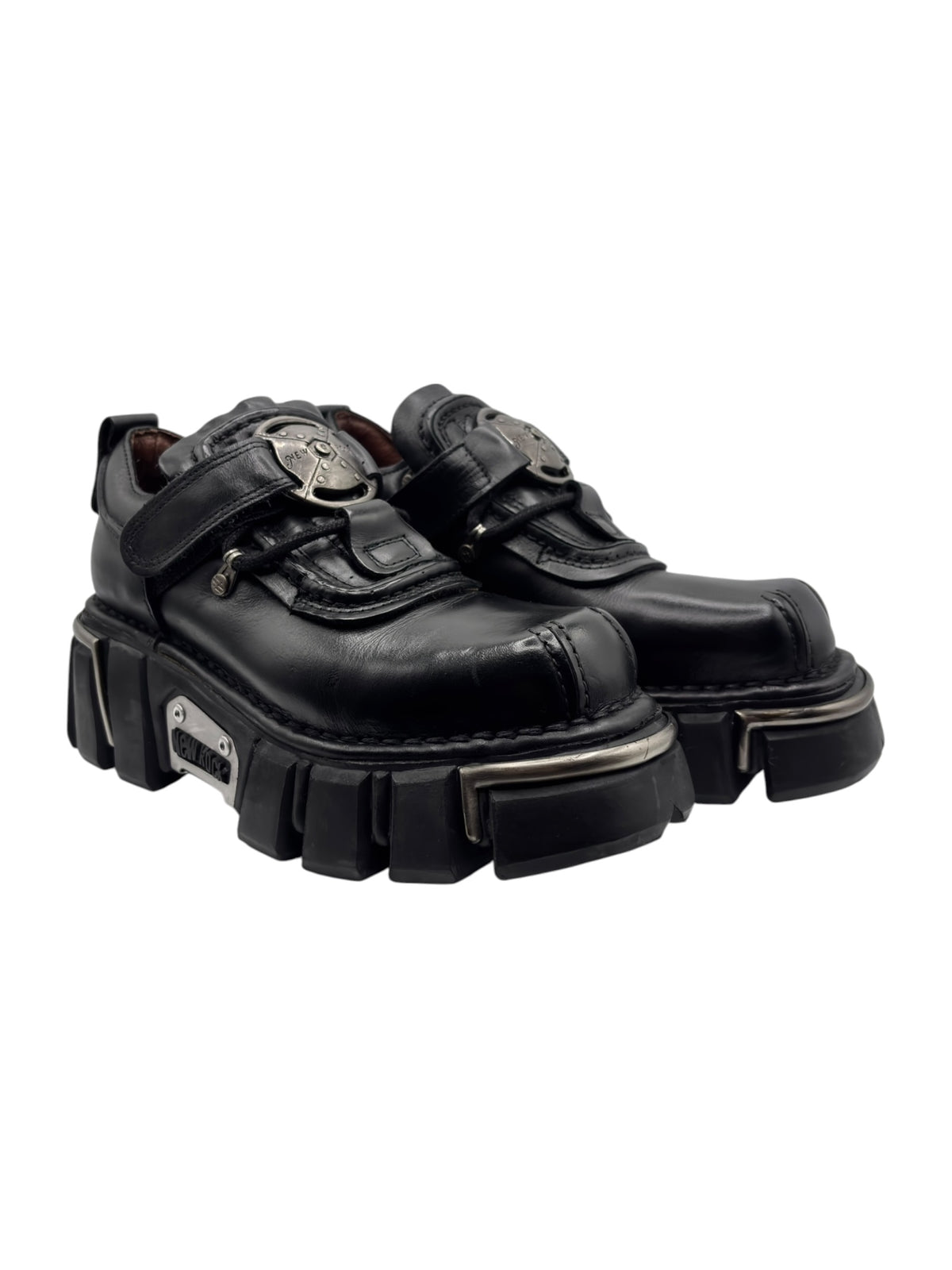 Vintage black platform boots with side buckle straps and chunky tread, angled