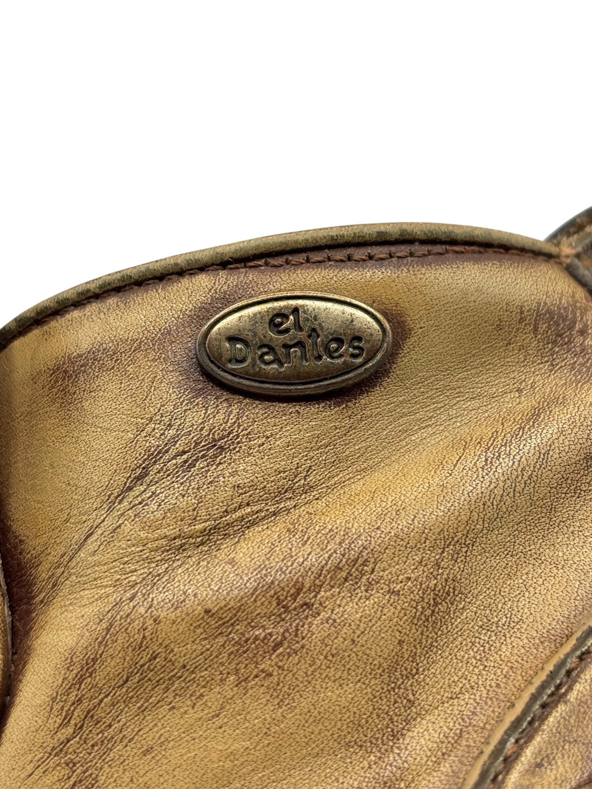 El Dantes embossed oval logo on khaki brown leather boot upper
