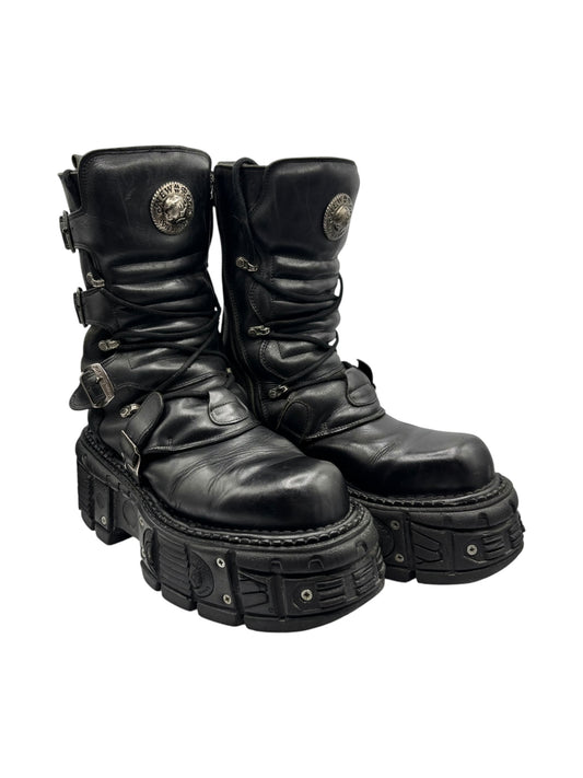 Black leather platform boots in a low side profile with buckle straps