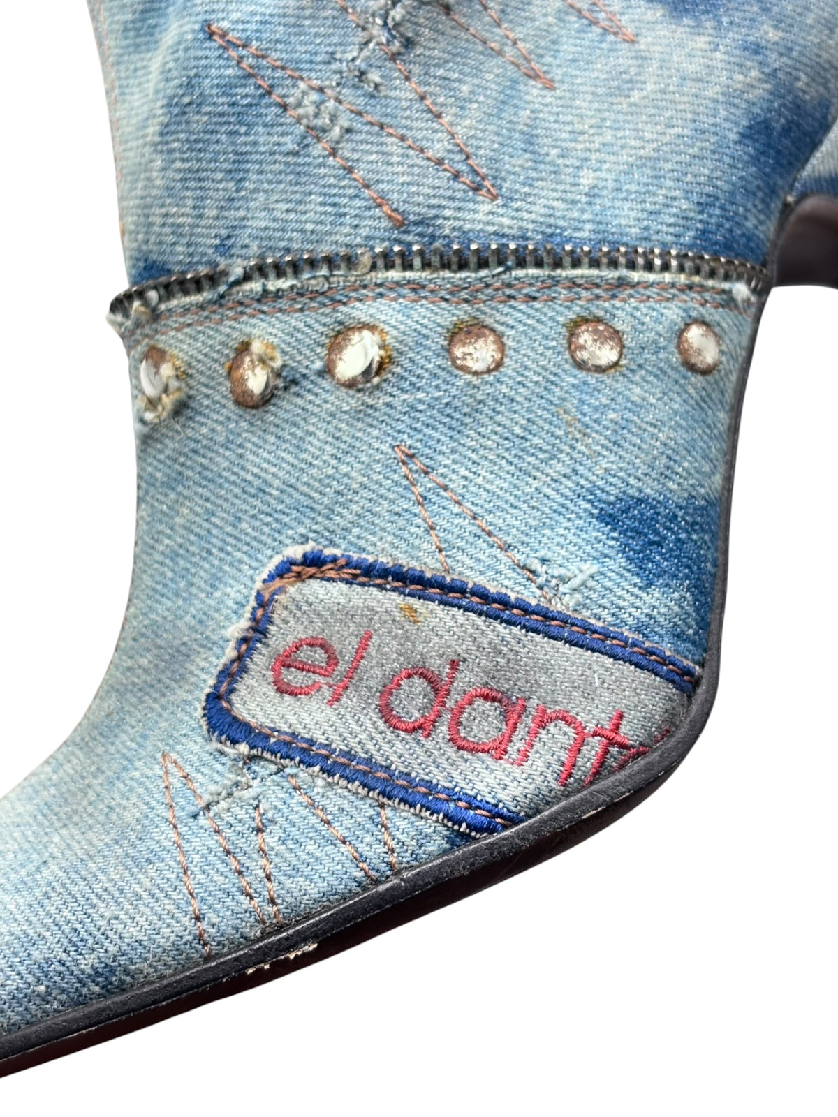 Mid-calf denim boots cuff with stud trim and embroidered “el dant” logo patch