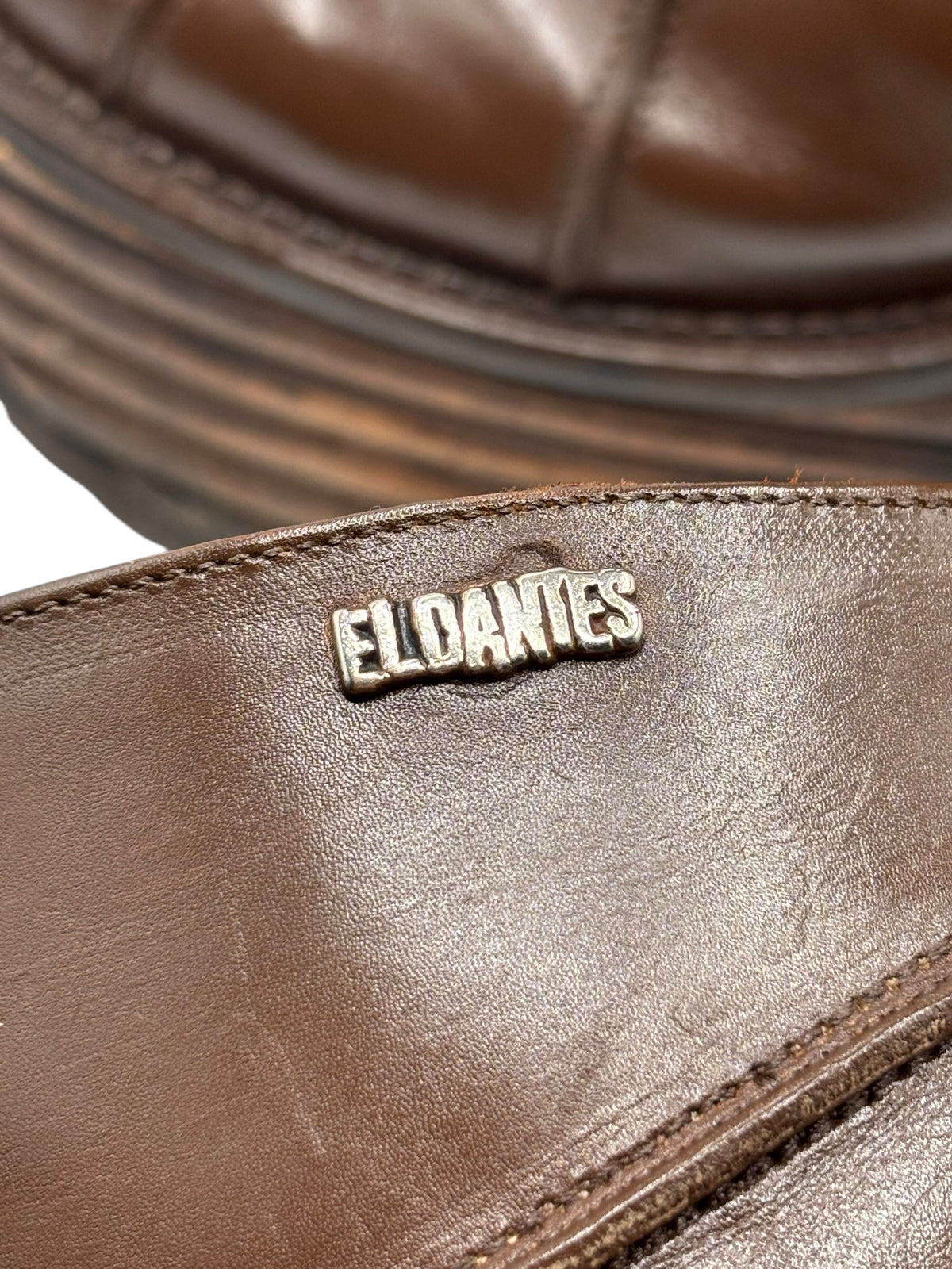 Boot interior logo patch reading El Dantes on brown leather lining