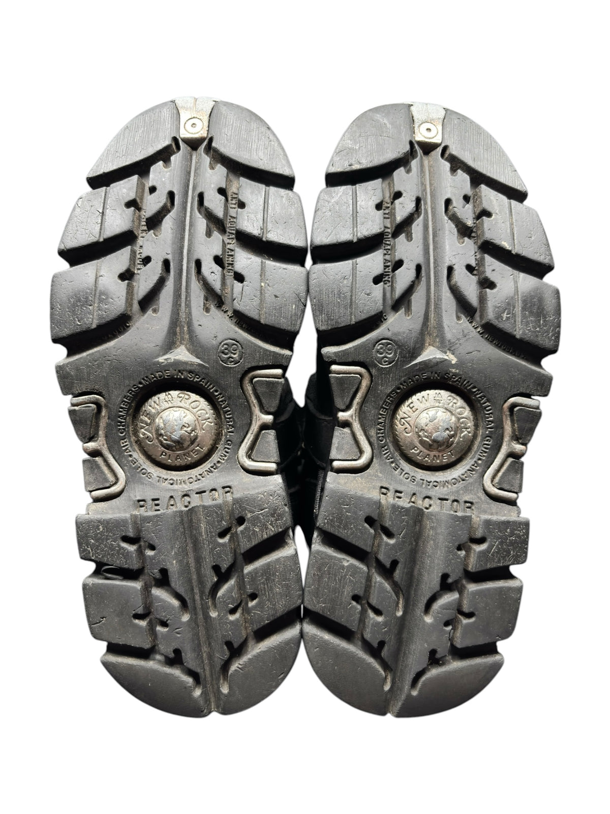 Pair of boots showing outer soles with chunky tread pattern
