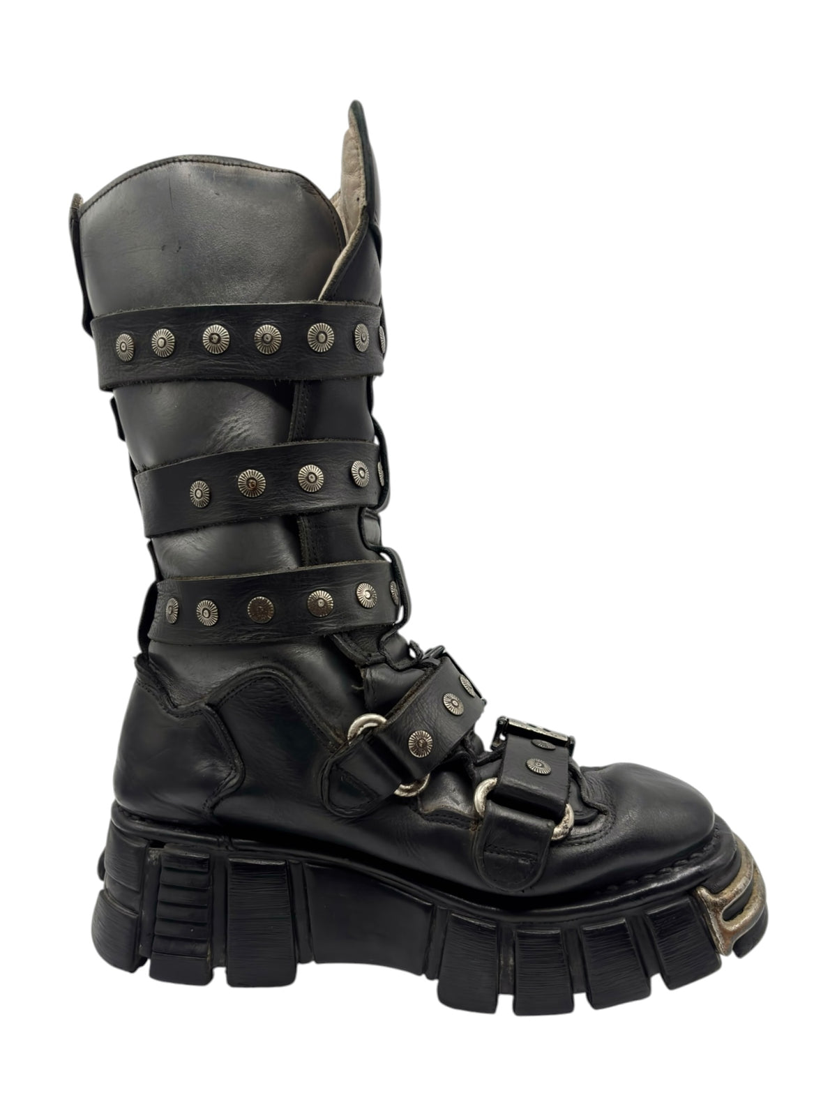 Dark leather studded strap boot with buckle straps, harness detail, and thick sole