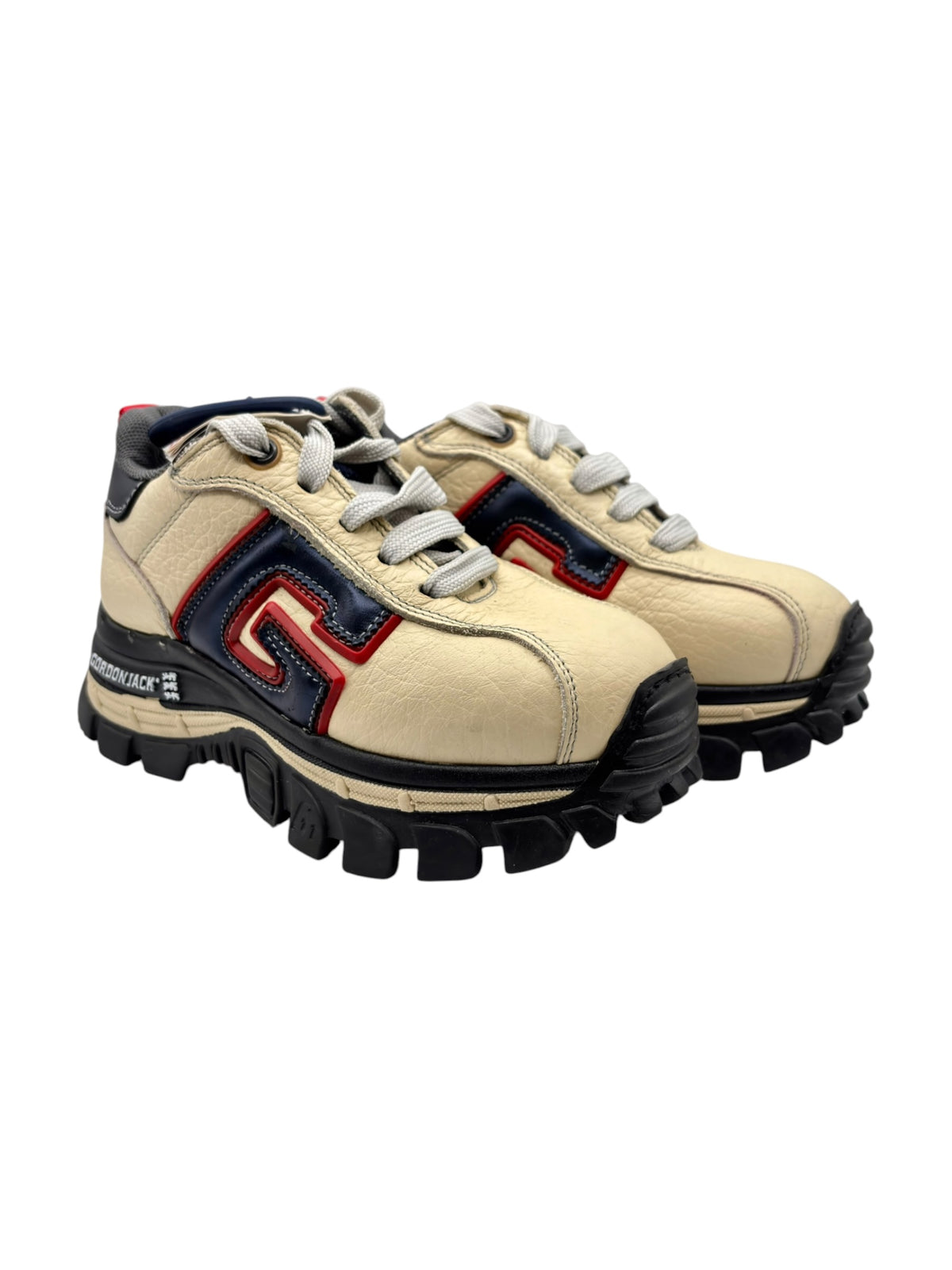 Beige platform sneakers with lace-up front, chunky tread sole, red and navy logo panel
