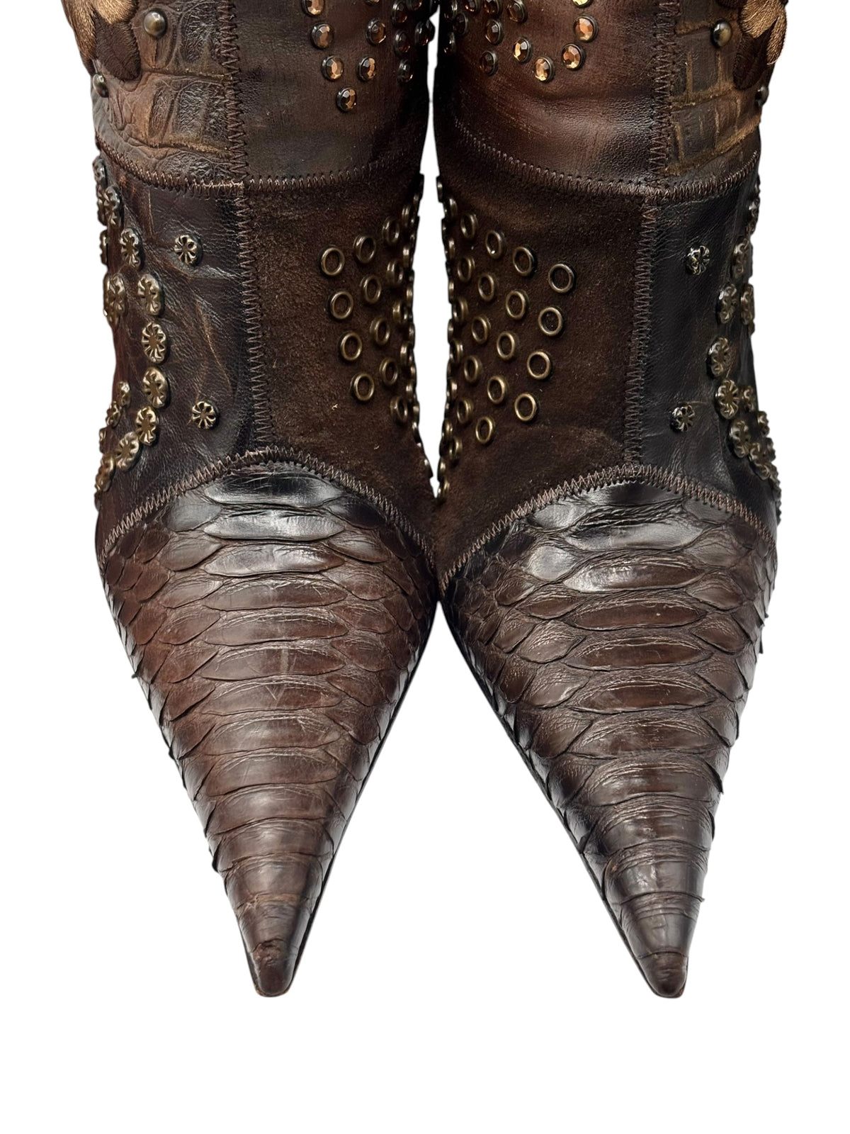 Vintage knee-high leather boots with textured vamps, bronze stud details, and pointed toe