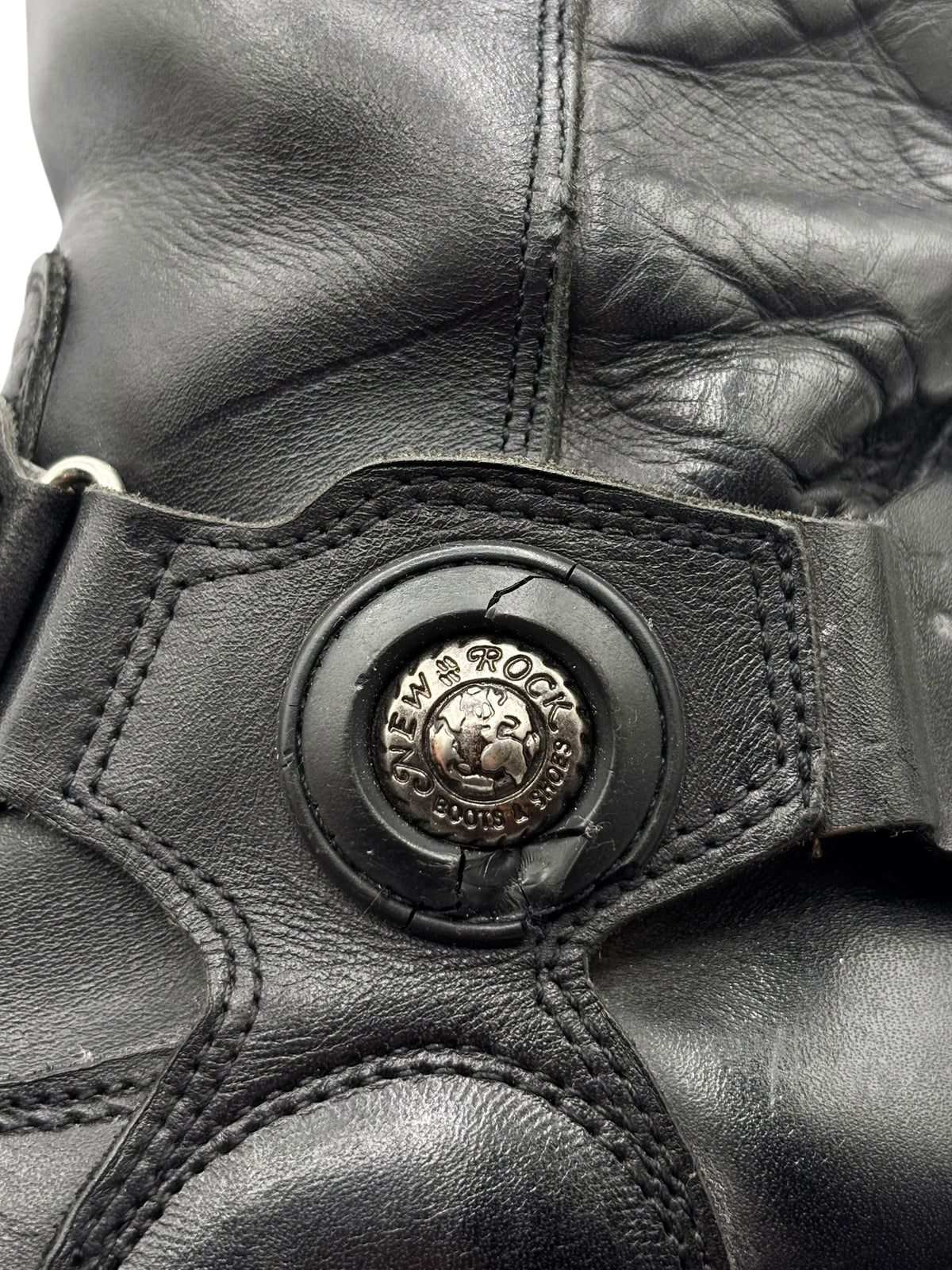 Black leather mid-calf biker boot upper with New Rock circular logo buckle