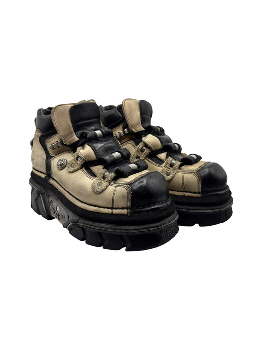 Beige and black platform boots, lace-up with side strap hardware and thick sole