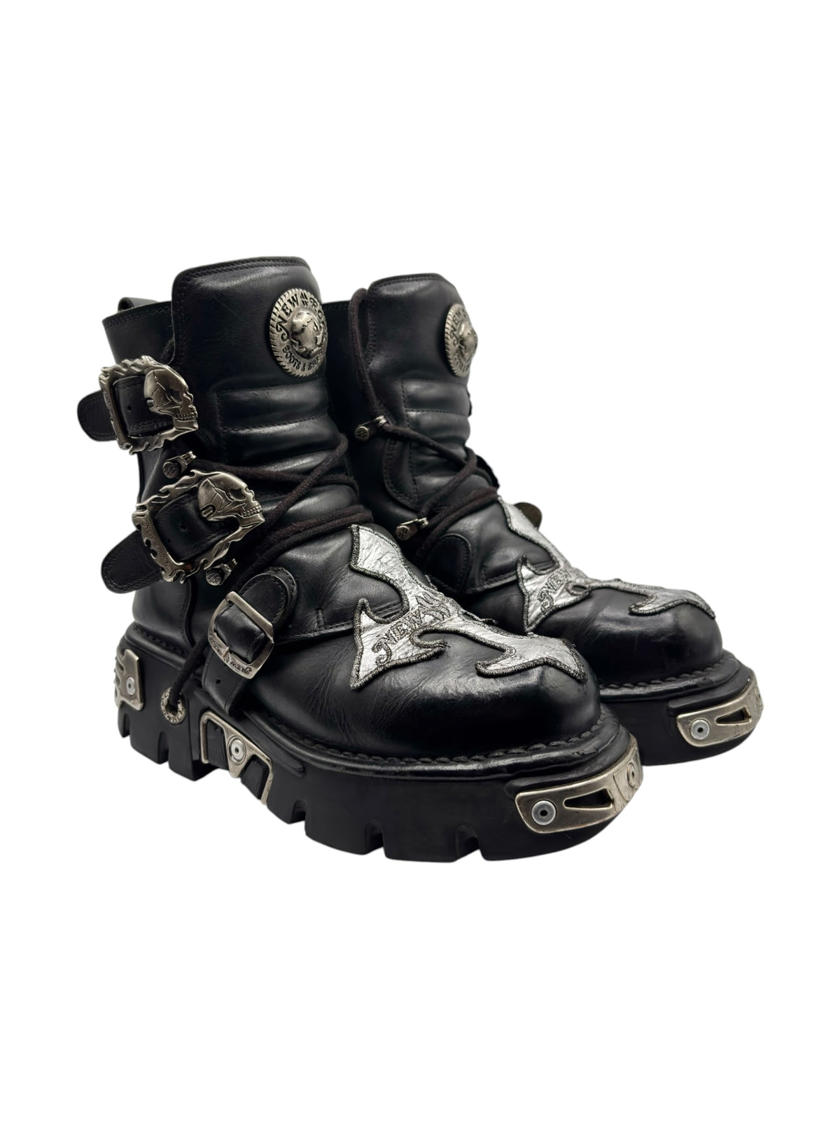 Black chunky lace-up boots with side buckles, silver cross patches, rugged sole