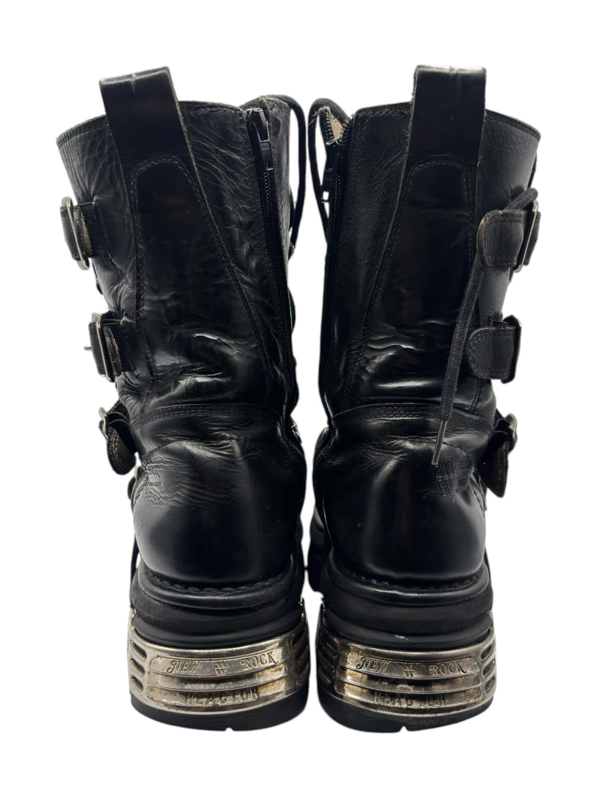 Rear view of black mid-calf reactor boots with heel plates and strap buckles