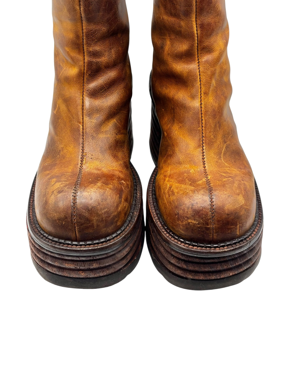 Front view of brown leather platform boots with vertical stitching and stacked soles