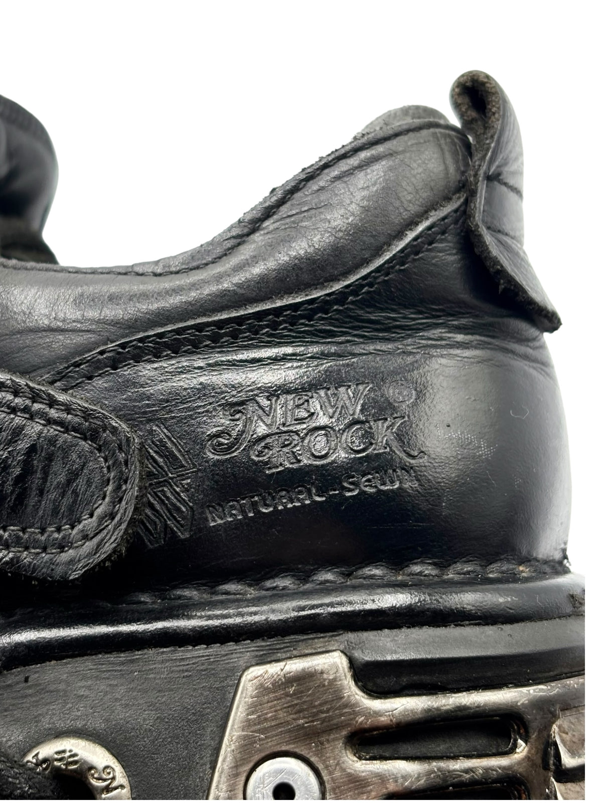 Side close-up of black boots with “New Rock” embossing near the heel.