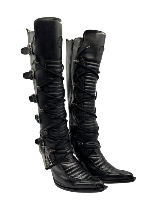 Black knee-high leather boots with lace-up straps and buckled side details