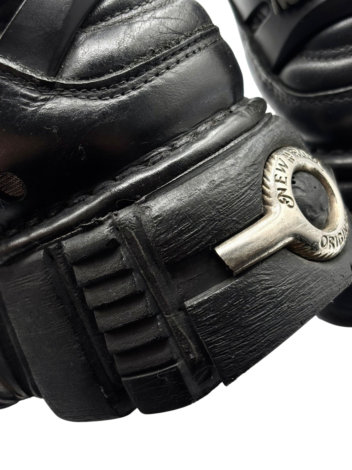 Close-up of black leather strap and metal side buckle on the platform boot