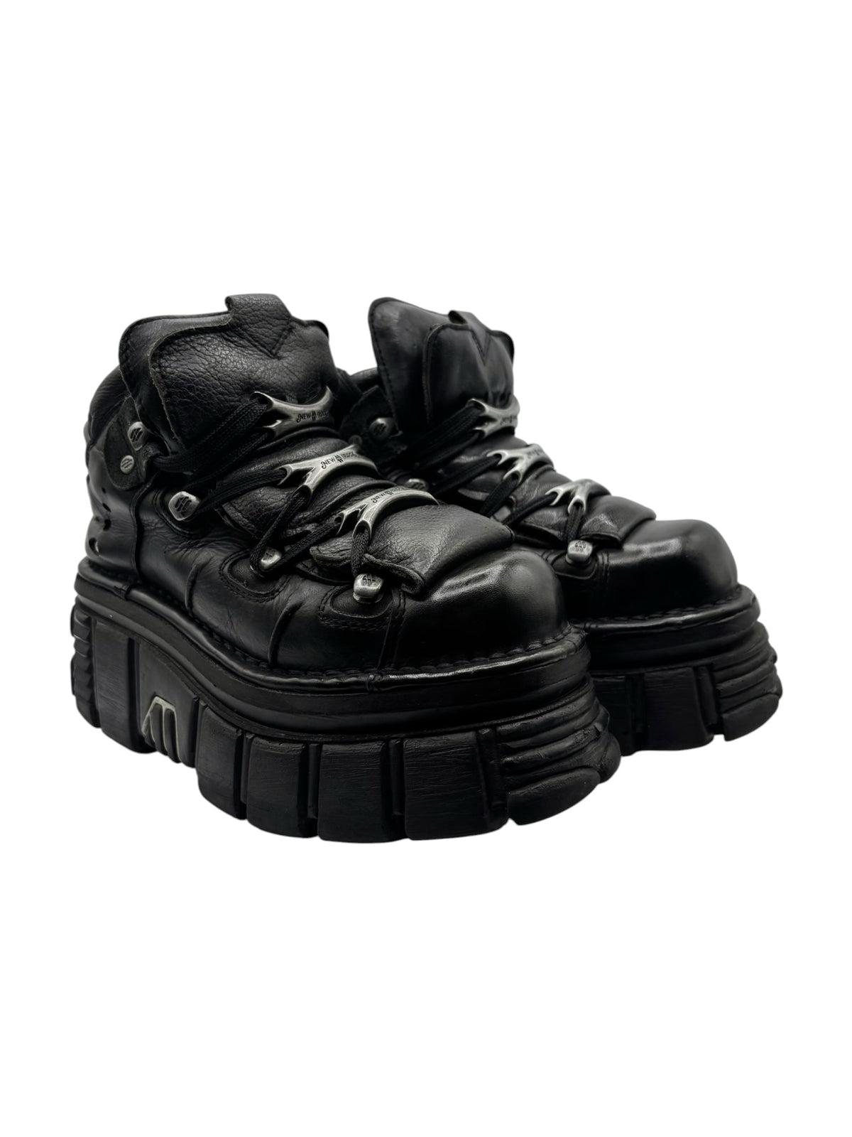 Black lace-up platform boots with sculpted upper and chunky tread sole.