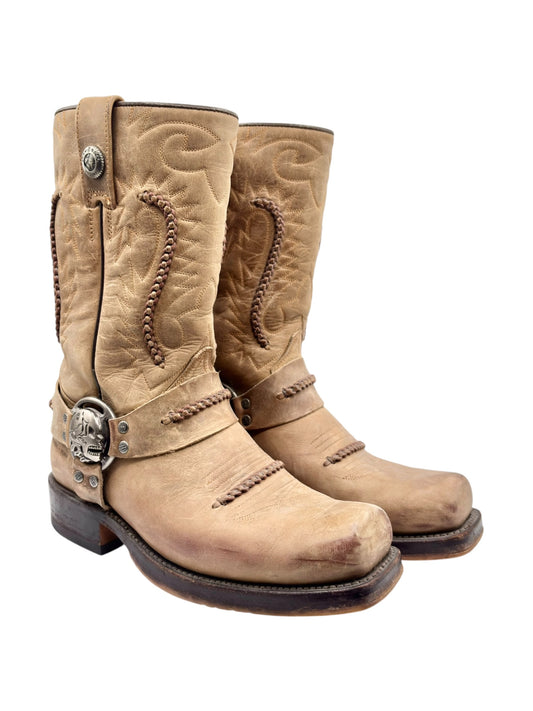 Beige cowboy boots with skull buckle, quilted shaft embroidery, and low heel