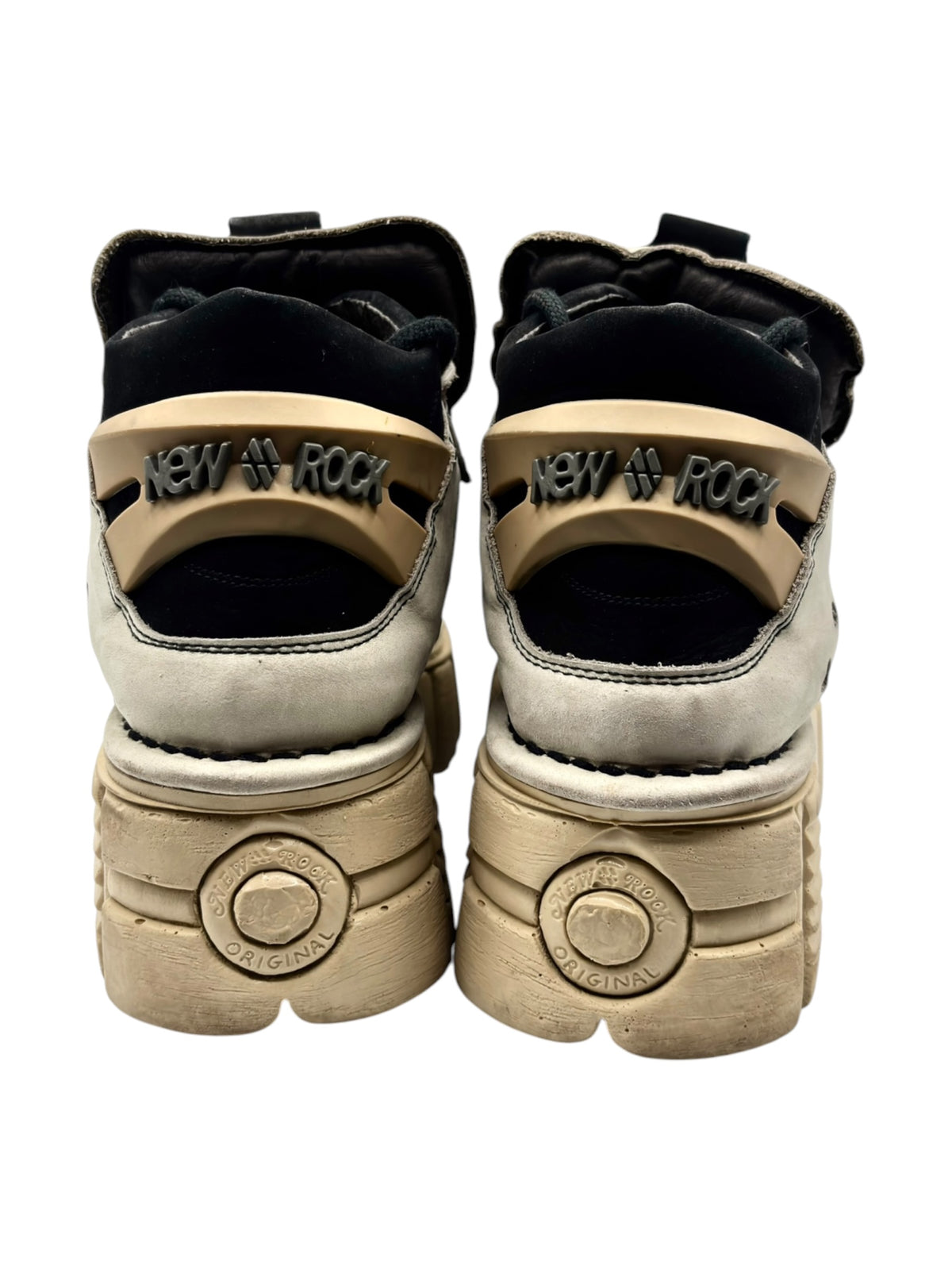 Back view of beige platform boots with black heel lining and “ORIGINAL” medallion