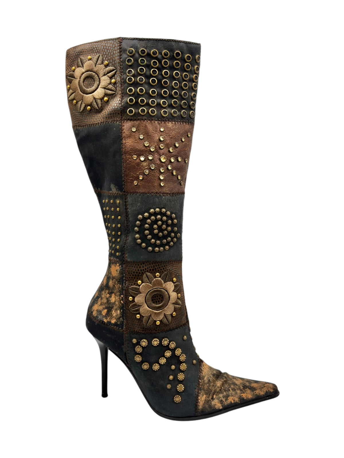 Knee-high patchwork boots with stiletto heel and gold studded flower medallions.