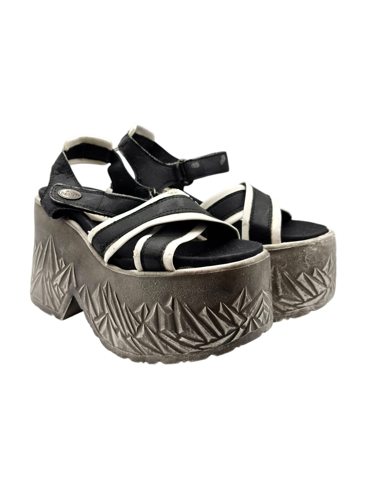 Black and white platform sandals with ankle strap and textured gray geometric sole