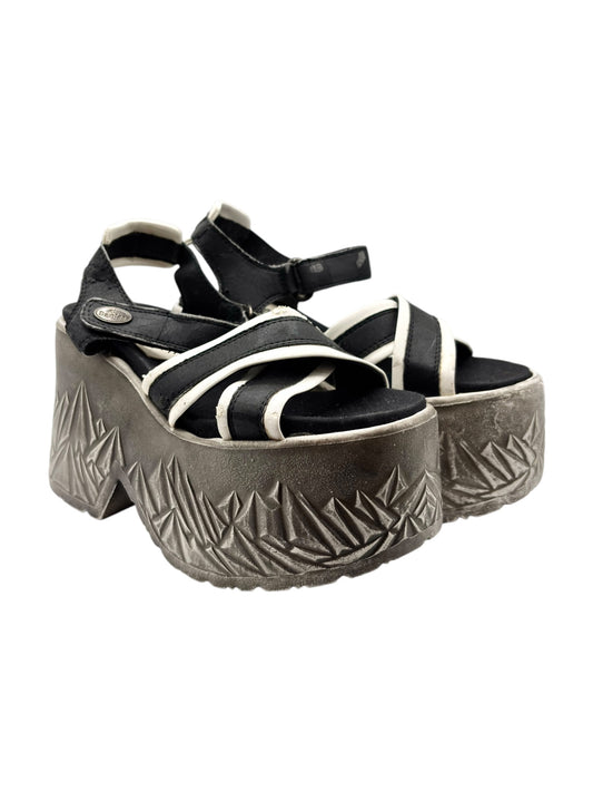 Black and white platform sandals with ankle strap and textured gray geometric sole