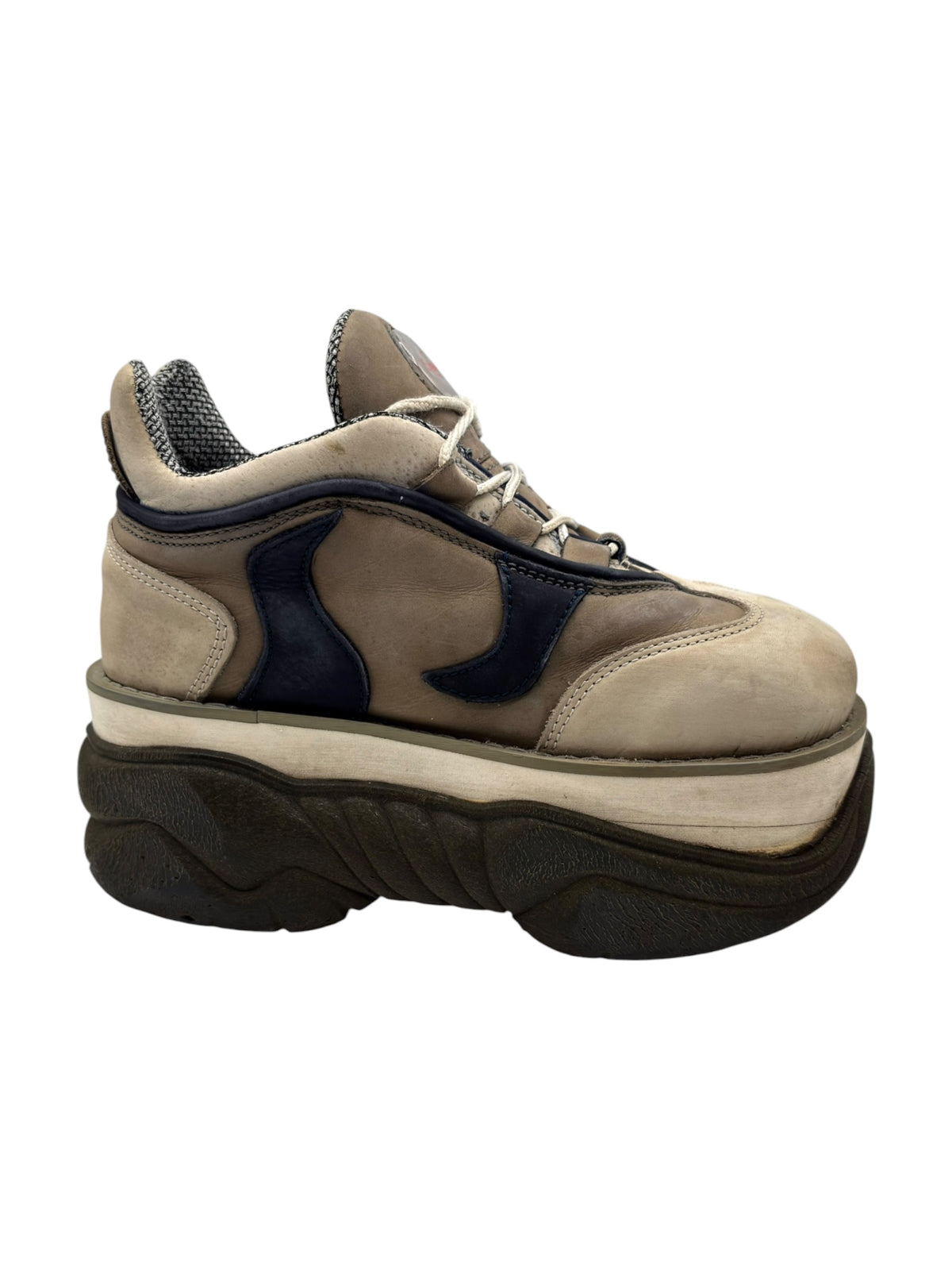 Beige suede platform boot with navy overlays, lace-up closure, and textured collar