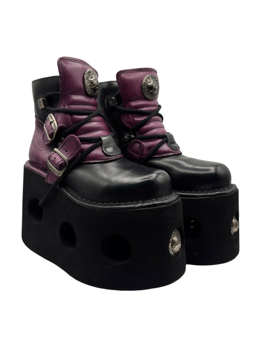 Purple and black platform leather boots with thick sole, side straps, and buckles